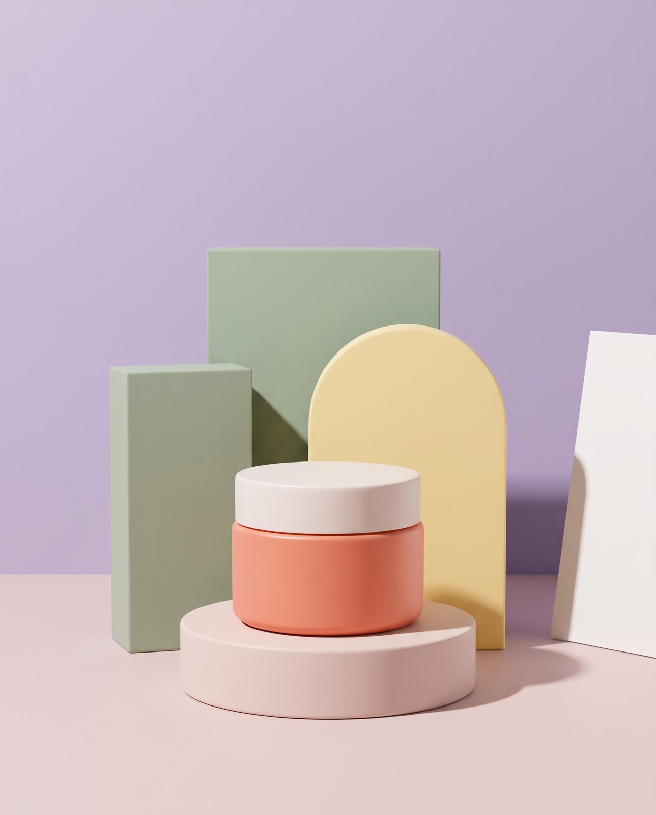 The coral cream jar with its off-white lid on a round plinth among pastel blocks on a lilac set