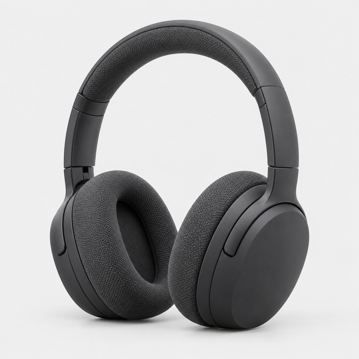 Charcoal over-ear headphones with fabric ear cushions on a plain background