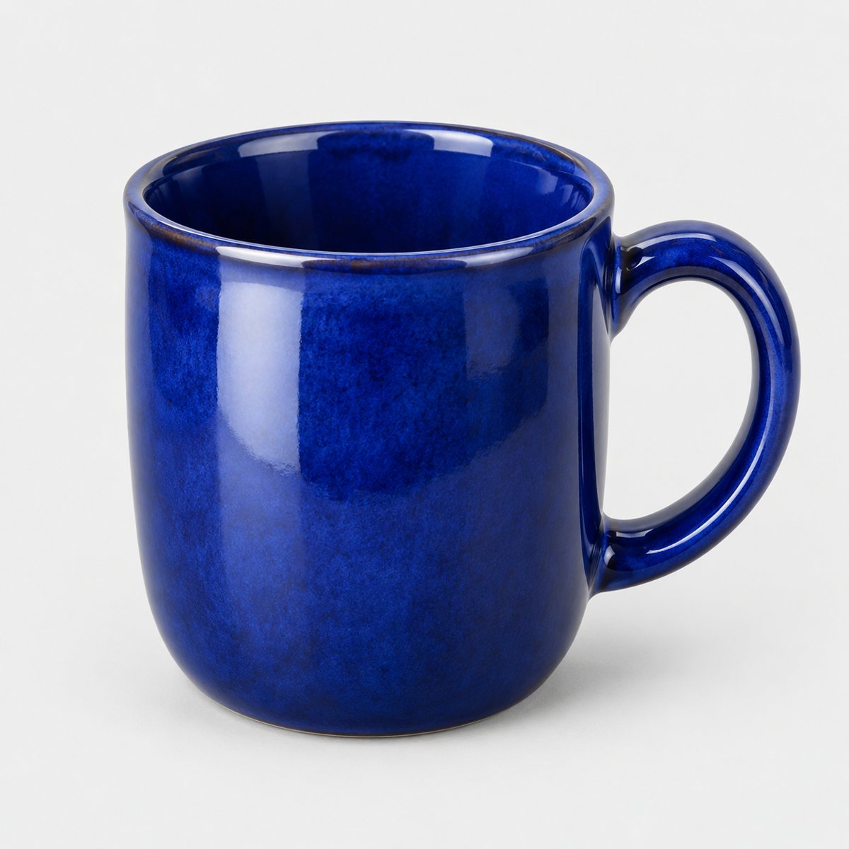 The original photo: a cobalt blue glazed mug on a plain background